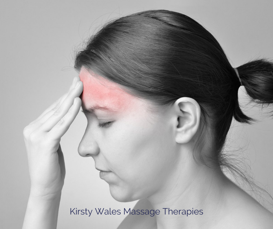 Person with a headache Headache alert Person rubbing forehead to alleviate tension caused by a headache.